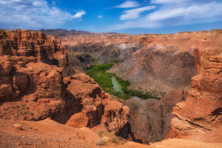 Beautiful Clay castles in Canyon of Charyn River in Kazakhstan, a beautiful view of the clay rocks and the road to the gorge on a sunny dayの写真素材