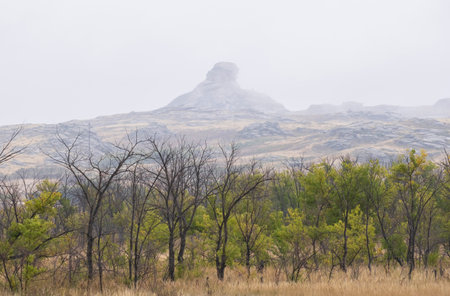 layered rocks of bizarre shapes in the autumn fog - this is the Kazakh Upland, mountains in Eastern Kazakhstan.の写真素材
