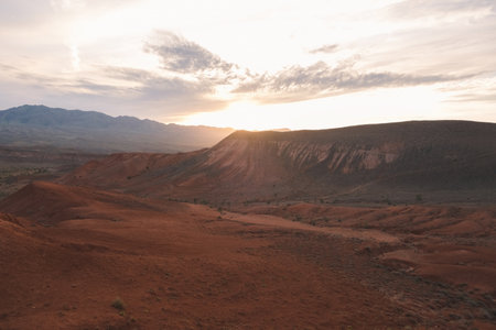 Epic sunset over the red mountains of Bogutty add color to the wild desert landscapeの写真素材