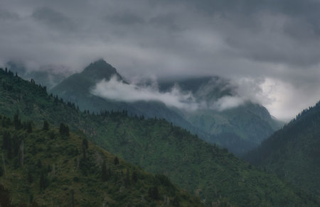 gloomy and dark mountains in heavy clouds before storm, Tien Shan, Zailiyskiy Alatau in Almaty...