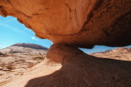Amazing rock remnant Stone mushroom, or Gate, created by wind erosion, against a clear sky in the mountains of Bektau Ata, Kazakhstanの写真素材