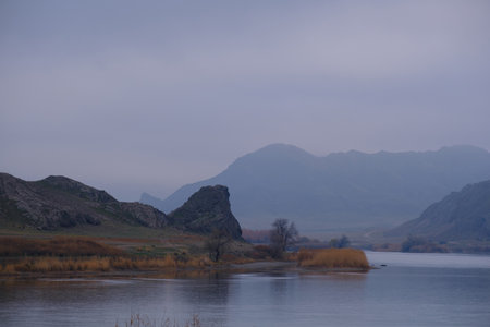 Autumn on the river Or in Kazakhstan, A calm landscape with mountains, river and autumn vegetation...