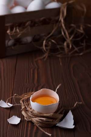 White fresh brocken egg on wooden background, closeupの写真素材