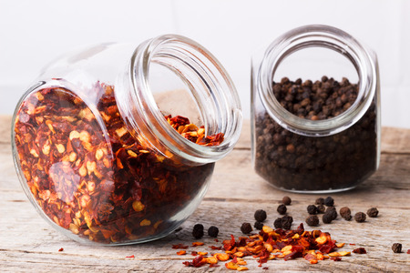 Chili flakes and black pepperの写真素材