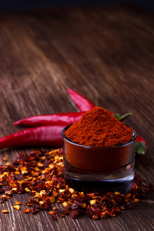 Chili peppers on rustic background, fresh, seeds and powderの写真素材
