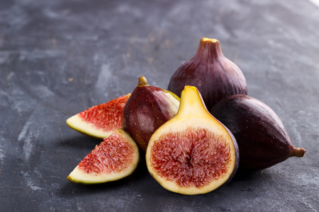 Ripe figs on dark rustic background, selective focus
