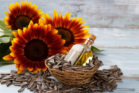 Sunflower Oil with seeds on vintage wooden backgroundの写真素材