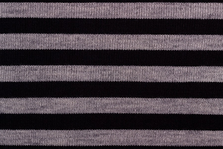 Texture of striped knitted woolen fabric for wallpaper and an abstract background