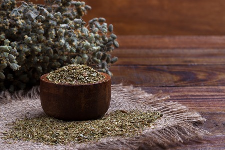 Bunch of organic dry oregano on old wooden backgroundの写真素材