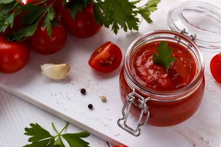 tomato sauce with garlic parsley,black and white pepper in a white bowl closeup.horizontal top viewの写真素材