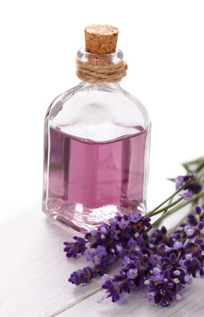 lavender flowers and essential oil over white background. Spa and wellness settingの写真素材