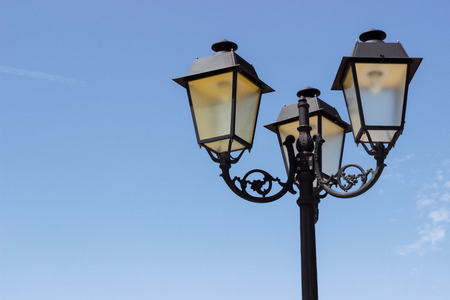 Vintage street light over blue sky backgroundの写真素材