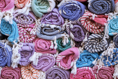 Colorful blankets, rolled up in a roll on the old market, traditional textiles.の写真素材