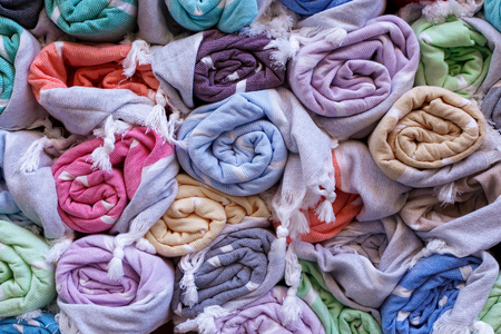 Colorful blankets, rolled up in a roll on the old market, traditional textiles.