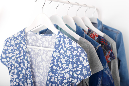 Summer, autumn, spring clothes hanging on a rack, trending conceptの写真素材