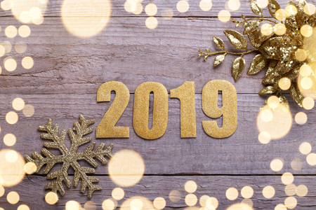 Happy New Year 2019 golden decoration and numbers on natural barn wood backgroundの写真素材