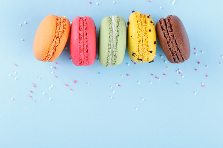 Colorful french macarons on blue background, traditional desert in Franceの写真素材