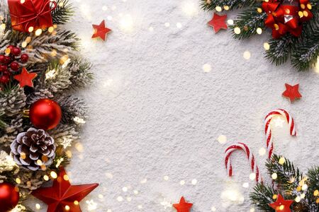 Red star gift box candy cane balls and fir tree branch Christmas decorations on grey stone background flat lay copy spaceの写真素材