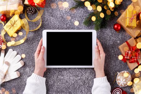 Woman holding tablet, christmas decorations, online shopping, sending e-mail, cozy concept