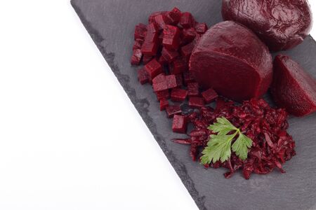 Boiled beetroot cut into slices on the black slate stone, copy spaceの写真素材
