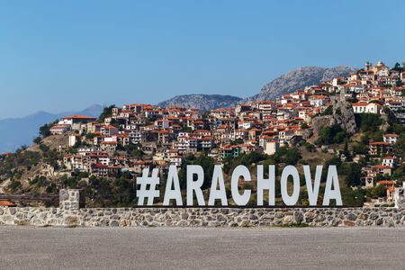 Arachova village famous tourists attraction on the Parnassos Mountain in Greece. Name of the place at the entrance made of steelの写真素材
