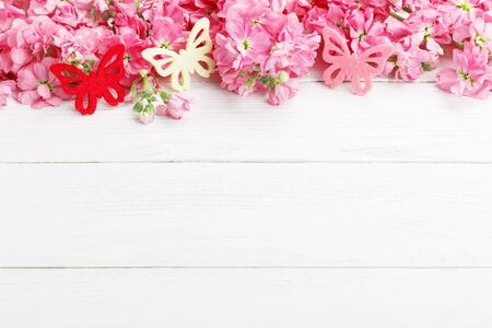 Fragrant pink spring flowers matthiola over white wooden background, copy space flat layの写真素材