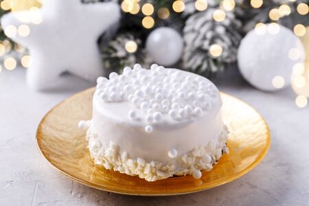 White chocolate Christmas cake on golden plate with festive decorations,horizontalの写真素材