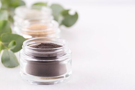 Black cosmetic clay powder for skin and hair, spa and wellness, natural cosmetics on white background close upの写真素材