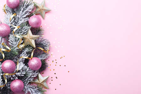 Christmas ornaments on pink background, golden stars and confetti, copy spaceの写真素材