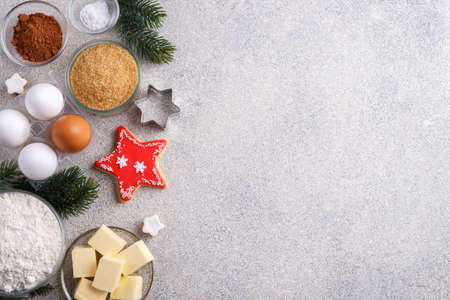 Winter holidays baking background, flour, bakeware,sugar, butter, cookie cutter,eggs,cinnamon and...
