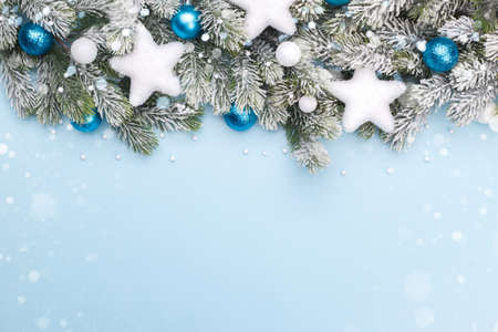 Christmas or new year card template, pine tree branch with white modern festive ornaments on blue...