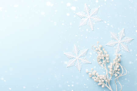 White decorative Christmas or New year ornaments and snow flakes on blue trendy background with copy...