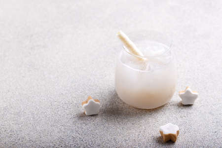 Glass of fresh cold lychee juice with ice grey stone background copy spaceの写真素材