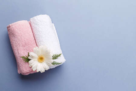 Spa setting, aromatherapy health and wellness on grey background, copy space flat lay, Pink and white towels and flowerの写真素材