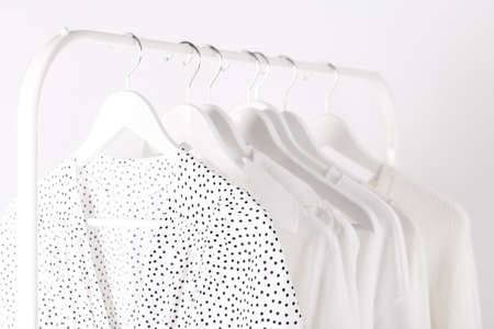 White spring summer female clothes hanging on a rack in a shopの写真素材