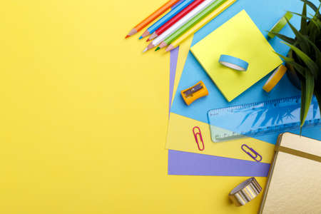 Back to school concept. Colorful stationary school supplies on yellow  background, space or text flat layの写真素材