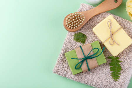 Hand made soap with olive and argan oil, zero waste reusable bathroom items on green backgroundの写真素材