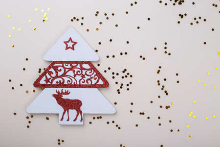 Christmas or New Year ornaments, flat lay on beige background with sparkling glitter confetti, copy spaceの写真素材