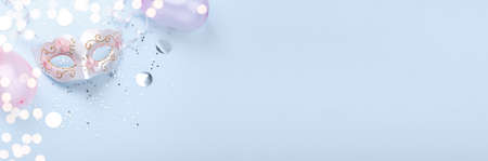 Carnival mask and confetti on blue background copy space flat lay banner, pastel clorsの写真素材