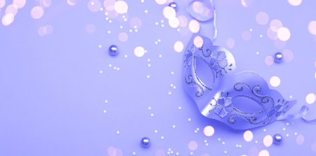 Carnival mask and confetti tonned with color of the year 2022 Very peri, copy space flat layの写真素材