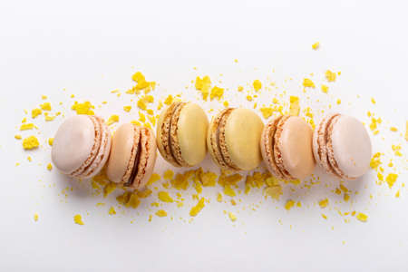 Yellow and beige french macarons on pastel background traditional dessert in Franceの写真素材