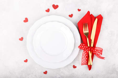 Romantic table setting on white stone table. Valentine's day card templateの写真素材