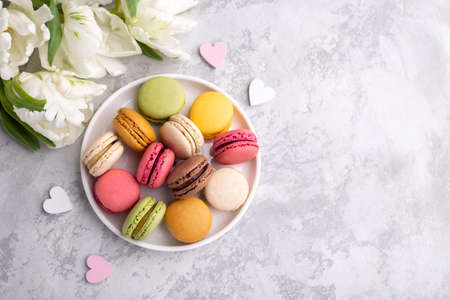 Colorful french macarons on grey stone background traditional dessert in Franceの写真素材
