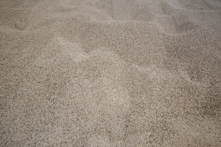 Rough Mediterranean sand texture close up, summer tine