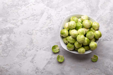 Brussel sprout, raw healthy vegetable on grey stone background