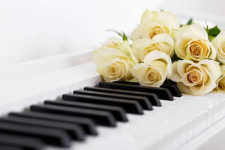 Romantic concept, piano and bouquet of white roses, close upの写真素材