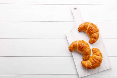 Traditional french croissant on white wooden table, tasty breakfastの写真素材