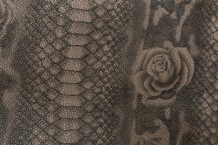 The texture of the skin of a reptile with a pattern of flowers