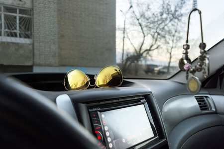 Chain of coins and sunglasses in the car, close, selective focusの写真素材