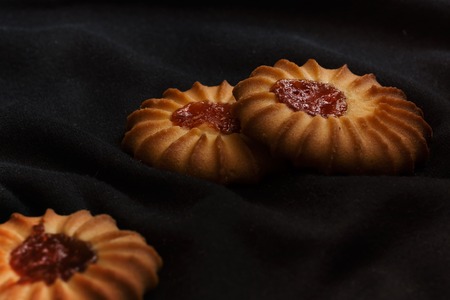 Three cookies with jam in dark and moody styleの写真素材